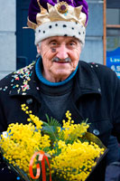 Binche festival carnival in Belgium Brussels. Binche, Hainaut, Belgium - Stand selling flowers during carnival parade in the streets on Mardi Gras. Belgium, carnaval of Binche. UNESCO World Heritage Parade Festival. Belgium, Walloon Municipality, province of Hainaut, village of Binche. The carnival of Binche is an event that takes place each year in the Belgian town of Binche during the Sunday, Monday, and Tuesday preceding Ash Wednesday. The carnival is the best known of several that take place in Belgium at the same time and has been proclaimed as a Masterpiece of the Oral and Intangible Heritage of Humanity listed by UNESCO. Its history dates back to approximately the 14th century.